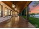 Covered outdoor living area with stone accents, offering a relaxing space to enjoy the peaceful lake views and serene ambiance at 8066 Edgewater Dr # 103, Norwood, NC 28128