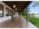 Covered patio with stone accents, ceiling fans, and lake views at 8066 Edgewater Dr # 103, Norwood, NC 28128