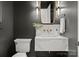 Stylish powder room featuring a floating marble sink, gold fixtures, and a modern aesthetic at 8066 Edgewater Dr # 103, Norwood, NC 28128