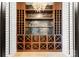 A custom wine cellar features wooden racks, shelving, and stylish lighting for showcasing your collection at 8066 Edgewater Dr # 103, Norwood, NC 28128