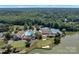Aerial view of community amenities including pool, tennis courts, golf course, clubhouse, and waterfront views at 8117 Rising Meadow Rd, Charlotte, NC 28277