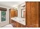 Bright bathroom features a double sink vanity with wooden cabinets and a large window offering ample natural light at 8117 Rising Meadow Rd, Charlotte, NC 28277