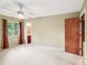 Inviting bedroom boasts a ceiling fan, window with green view, and doorway to an ensuite bathroom at 8117 Rising Meadow Rd, Charlotte, NC 28277