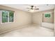 Cozy bedroom features a ceiling fan and views of the exterior at 8117 Rising Meadow Rd, Charlotte, NC 28277