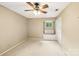 Neutral bedroom with a ceiling fan and closet for optimal storage and a built in bench seat under the window at 8117 Rising Meadow Rd, Charlotte, NC 28277