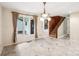 Open dining room featuring marble floors, large windows, chandelier, and staircase at 8117 Rising Meadow Rd, Charlotte, NC 28277
