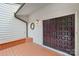 Welcoming entrance with dark double doors, a wreath, and a quaint porch area with seating at 8117 Rising Meadow Rd, Charlotte, NC 28277