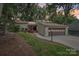 Charming exterior view of a home with a two-car garage and a neatly landscaped front yard at 8117 Rising Meadow Rd, Charlotte, NC 28277