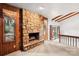 Cozy living room with exposed beams, wood paneling, and a stone fireplace at 8117 Rising Meadow Rd, Charlotte, NC 28277