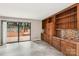 Bright living room featuring sliding doors leading to wooden deck and built-in wooden shelving at 8117 Rising Meadow Rd, Charlotte, NC 28277
