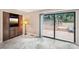 Bright living room with sliding glass doors to an outdoor deck and gray marble floors at 8117 Rising Meadow Rd, Charlotte, NC 28277