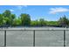 Community tennis courts with a fence, surrounded by trees offers a recreational sport for the community at 8117 Rising Meadow Rd, Charlotte, NC 28277