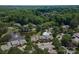 Scenic aerial view of the community featuring lush greenery, a pond, and a sparkling pool at 9006 Four Mile Creek Rd, Charlotte, NC 28277