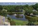 Drone shot over a pond and residences with a fountain at 9006 Four Mile Creek Rd, Charlotte, NC 28277