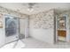 Bedroom with sliding glass doors to deck, chair rail, and adjoining bath at 9006 Four Mile Creek Rd, Charlotte, NC 28277