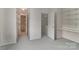 Bright bedroom with carpeted floor, and a view to other rooms at 9006 Four Mile Creek Rd, Charlotte, NC 28277