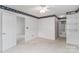 Comfortable bedroom with patterned wallpaper, neutral carpet, and adjoining bathroom access at 9006 Four Mile Creek Rd, Charlotte, NC 28277