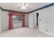Cozy bedroom with plush carpeting, a large window with curtains, and floral wallpaper accents at 9006 Four Mile Creek Rd, Charlotte, NC 28277