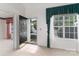 Bright foyer featuring tile flooring, a window with decorative curtains, and an open view into other rooms at 9006 Four Mile Creek Rd, Charlotte, NC 28277