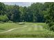 Scenic golf course view with lush green fairway, mature trees, and sand traps, ideal for golf enthusiasts at 9006 Four Mile Creek Rd, Charlotte, NC 28277