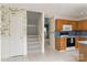 This kitchen has a breakfast bar, wood cabinets, and a view to the stairs at 9006 Four Mile Creek Rd, Charlotte, NC 28277