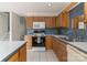 This kitchen features blue countertops, wood cabinetry and modern appliances at 9006 Four Mile Creek Rd, Charlotte, NC 28277