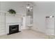 Spacious living room featuring a fireplace, vaulted ceilings, and an open staircase, enhancing the home's appeal at 9006 Four Mile Creek Rd, Charlotte, NC 28277