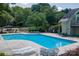 Beautiful community swimming pool with lounge chairs and well-maintained landscaping at 9006 Four Mile Creek Rd, Charlotte, NC 28277