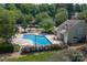 Inviting aerial view of a community pool surrounded by trees and residential buildings at 9006 Four Mile Creek Rd, Charlotte, NC 28277