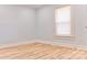 Bright bedroom with light-blue walls, wood floors, a window, and white trim at 102 Lake Dr, Hickory, NC 28601