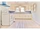 Spacious kitchen with white appliances, white cabinets, light-blue walls, and a tile floor at 102 Lake Dr, Hickory, NC 28601
