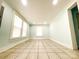 Bright room with neutral tile flooring, light blue walls, and multiple windows at 102 Lake Dr, Hickory, NC 28601