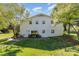 Rear of a brick home with a patio area, set in a lush lawn with mature trees and a walkout basement at 1041 Brawley School Rd, Mooresville, NC 28117
