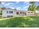 Charming white brick home featuring lush front yard and a cozy front porch at 1041 Brawley School Rd, Mooresville, NC 28117