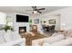 Bright living room boasts fireplace, ceiling fan and an adjacent dining area at 1041 Brawley School Rd, Mooresville, NC 28117