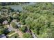 Lush green wooded lot with a home near a lake, showcasing the property's waterfront access and scenic location at 10419 Chelsea Bay Dr, Charlotte, NC 28278