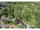 Aerial view of a wooded lot with a home, near a lake, showcasing the surrounding natural beauty at 10419 Chelsea Bay Dr, Charlotte, NC 28278