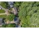 Aerial view of a home nestled among lush greenery, showcasing its roof, deck, and proximity to nature at 10419 Chelsea Bay Dr, Charlotte, NC 28278