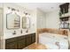 Bathroom features double sinks, bathtub, and decorative tile backsplash at 10419 Chelsea Bay Dr, Charlotte, NC 28278