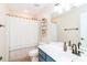 Full bathroom with shower, bathtub, white vanity, and blue cabinets at 10419 Chelsea Bay Dr, Charlotte, NC 28278