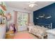 Charming bedroom with floral accents, pink curtains and an abundance of natural light at 10419 Chelsea Bay Dr, Charlotte, NC 28278