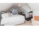 Bright bedroom with sloped ceilings featuring a bed, desk, and treadmill at 10419 Chelsea Bay Dr, Charlotte, NC 28278