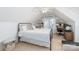 Bright bedroom with sloped ceilings, white bedding, and a built in office space at 10419 Chelsea Bay Dr, Charlotte, NC 28278