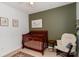 Cozy Bedroom with a wood crib, rocking chair, and neutral walls at 10419 Chelsea Bay Dr, Charlotte, NC 28278