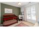 Cozy Bedroom with a wood crib, rocking chair, and neutral walls at 10419 Chelsea Bay Dr, Charlotte, NC 28278