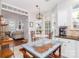 Bright breakfast nook with a round table and seamlessly connected to the living room for gatherings at 10419 Chelsea Bay Dr, Charlotte, NC 28278