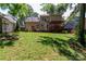 Exterior view of the home with a well-maintained lawn, patio, and mature trees at 10419 Chelsea Bay Dr, Charlotte, NC 28278