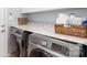 Convenient laundry room with modern washer and dryer units and stylish countertop for folding at 10419 Chelsea Bay Dr, Charlotte, NC 28278