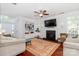 Inviting living room with fireplace, built-ins, hardwood floors, and comfortable seating at 10419 Chelsea Bay Dr, Charlotte, NC 28278