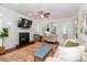 Cozy living room with fireplace, ceiling fan, and large area rug on wood floor at 10419 Chelsea Bay Dr, Charlotte, NC 28278